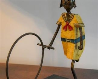 small sclupture, young girl hoop rolling