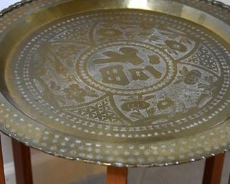large engraved brass platter on wooden stand