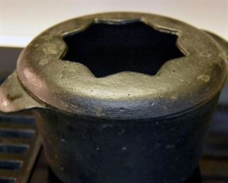 small cast iron pot with star cutout in lid