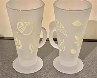 $14 - Pair frosted leaf decorated mugs with handles; 6" H x 3" diameter 