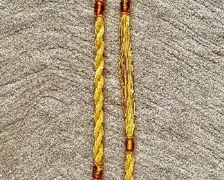 $250 - Twisted, beaded necklace; approx 24"L