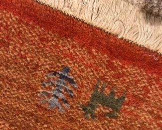 Love this rug with animal and person motif. Fits perfectly in a lodge or primitive setting