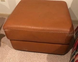 Nicely worn leather ottoman. Comfy and handy to have.