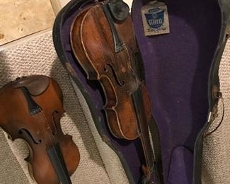 Love these old violins. One is marked "Ole Bull" with case