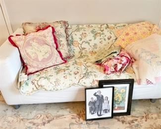 White small couch, vintage quilts, pillows and decorative linens, vintage framed prints 