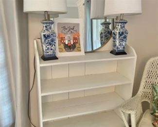 Vintage white bookcase, pair of blue and white ceramic lamps, large gold round mirror 