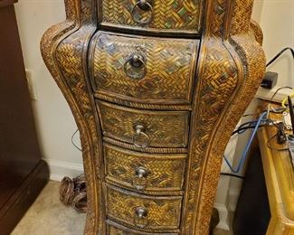 Beautiful intricate wicker small cabinet.
