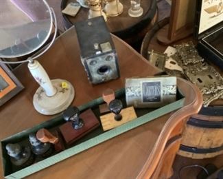 Vintage cameras, rubber stamps, light switch plates, and vanity makeup mirror