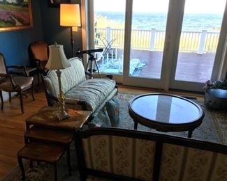 Down cushioned settees, round marble topped coffee table, beautiful view in the background