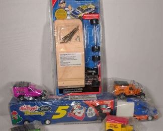 4 Kelloggs Matchbox Cars, One Model Making Racecar, and One Kelloggs Tractor Trailer