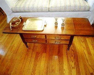 a drop leaf coffee table with drawers
