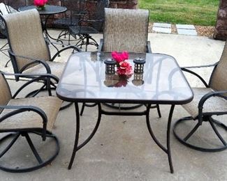 Patio Set Including Glass Top Table 28" x 40' x 40", Swivel Rocking Dining Chairs Qty. 4 And Solar Powered Lanterns Qty. 2