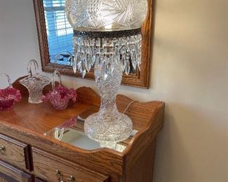 Bohemian (Czechoslovakian) cut glass lamp and shade in the style of Palda and Gebruder Zahn glass. The base with a flared foot and matching mushroom form shade with deeply cut patterns of diamonds, Brunswick stars and lines. The metal shade support with thick faceted crystal prisms hanging, single socket fixture, base