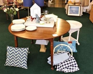 White tableware, pillows, white wicker table and round dining table are all for sale.