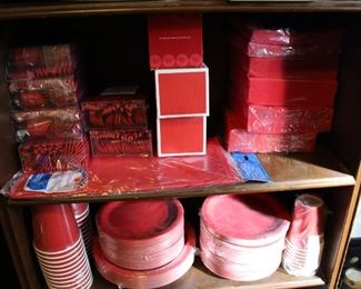 Lots of brand new, still in packages, napkins, cups, plates - lots of red