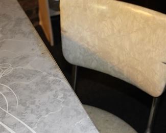 One chair has a small rip 