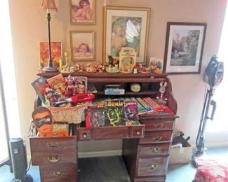 Contemporary roll-top desk and lots of children's books, comics,  and toys