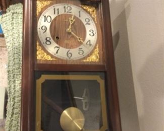 One of three wall clocks, complete with pendulum and key