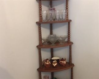 tall cherry display stand with an assortment of glassware