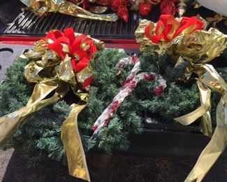 pair of Christmas wreaths with bow and candy canes
