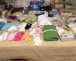 French provincial bed with selection of ladies gloves, bed linens, and other clothing