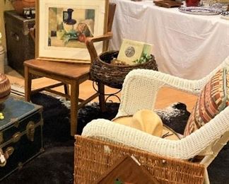 White wicker chair; decorative pillows