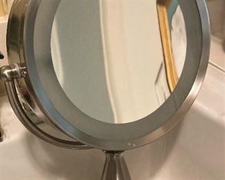 Lighted and magnified mirror