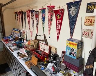 Sports pennants, power and antique handtools, toys, postcards from all regions and eras, vintage license plates, and aluminum extension ladder.