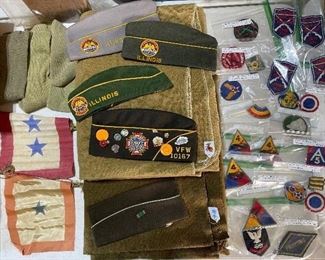 Authentic world war army blankets. World War II hat. Genuine World War II army patches. World War II army socks. World War II service flags. The light color like it could be World War I Vintage. Also some AMVETS and VFW hats and pins.