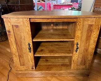 Sauder corner TV stand with storage underneath.