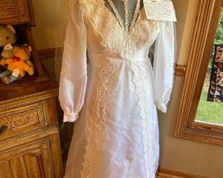1975 wedding dress and veil. Cathedral train with bustle. Cathedral length veil completely covers train of dress. Dress was worn once and then clean Ed and preserved at Marshall Fields. Preservation box included.