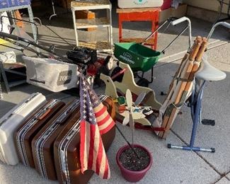 Toro lawnmower, Scotts  standard broadcast spreader, small vintage wooden kitchen table and metal rolling cart, Samsonite luggage, US Army cot, classic exercise bike, rocking child’s horse.