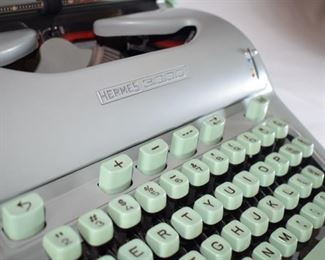 Hermes 3000 typewriter with brush and manual.