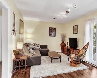 Rattan egg swivel chair; shag rug, rattan side table