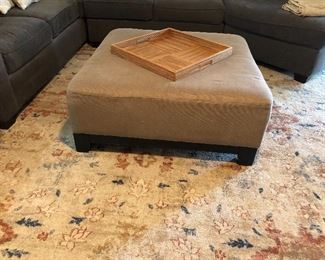 Large square ottoman; large rug.