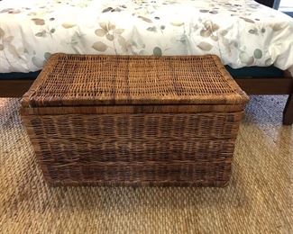 Large woven trunk, jute rug.