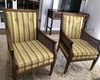 Two mid century chairs with caned side panels.