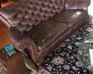 Leather couch has matching chair and ottoman another beautiful rug