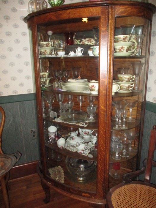 Antique oak china cabinet. China & stemware.