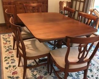 beautiful dining room table and chairs leaves stored inside table 