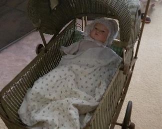 Antique baby carriage and baby dolls
