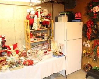 Lots of Christmas decorations, wreaths and refrigerator.