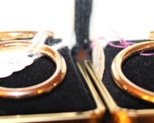 We have two pairs of gold hoop earrings.