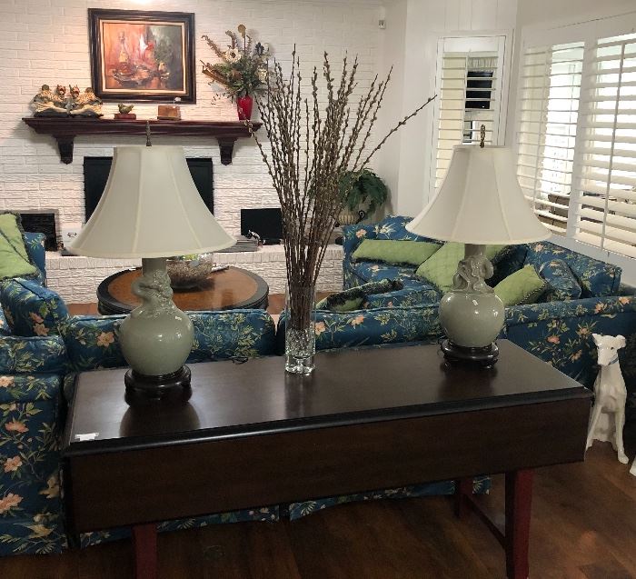 Beautiful drop leaf sofa table, three sofas, coffee table, and lamps.