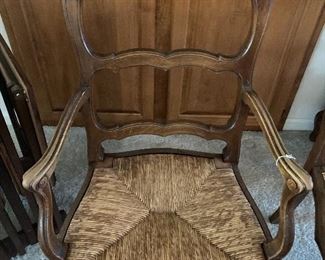 One of a pair of French-style armchairs with rush seats