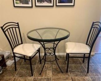 ROUND IRON AND GLASS 3 PIECE BISTRO SET W/ TABLE AND 2 CHAIRS  $150.00
WHY WE LOVE IT:
Beautiful bistro set including table and 2 side chairs. The table offers durable frame in elegant black finish and solid glass top, while the complementary chairs feature comfortably padded seat in cream colored upholstery. 
DETAILS + DIMENSIONS:
20"W x 20"D x 30"H
Chairs measure 36"H x 16"W x 18"D x 18" seat height
CONDITION: This set has been well cared for.  No visible scratches or chips....  condition is consistent with light use.  Please refer to photo's for a more detailed look at condition.  We make every attempt to list and photograph any defects or signs of wear that are significant to this sale. 