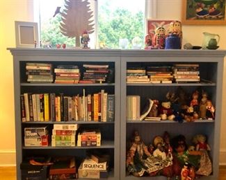 Bookshelves, books, games and foreign doll collections