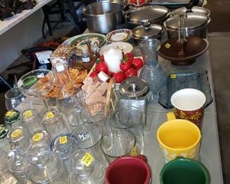 Lots of glasses and cups and overflow from kitchen.