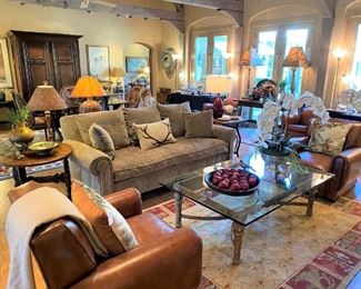 Ralph Lauren leather club chairs, heavy iron & glass coffee table, Oriental rugs, Barboglio bowl, down sofa, orchid arrangement 