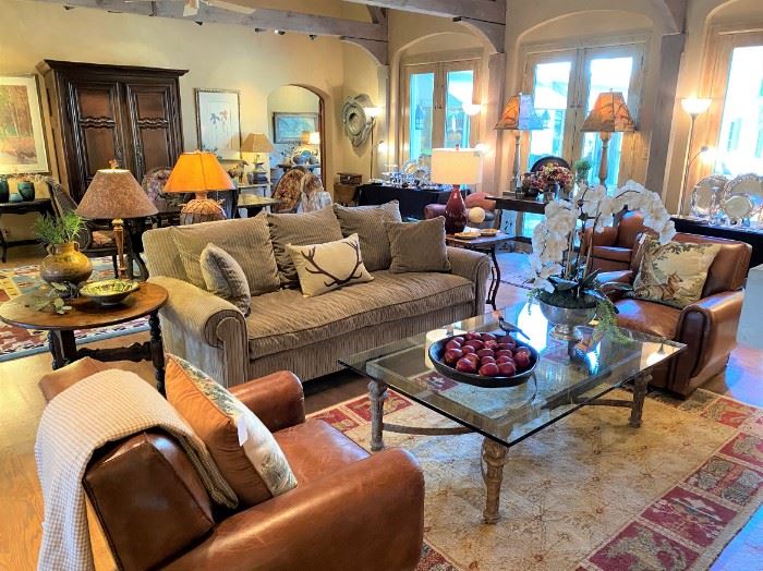 Ralph Lauren leather club chairs, heavy iron & glass coffee table, Oriental rugs, Barboglio bowl, down sofa, orchid arrangement 